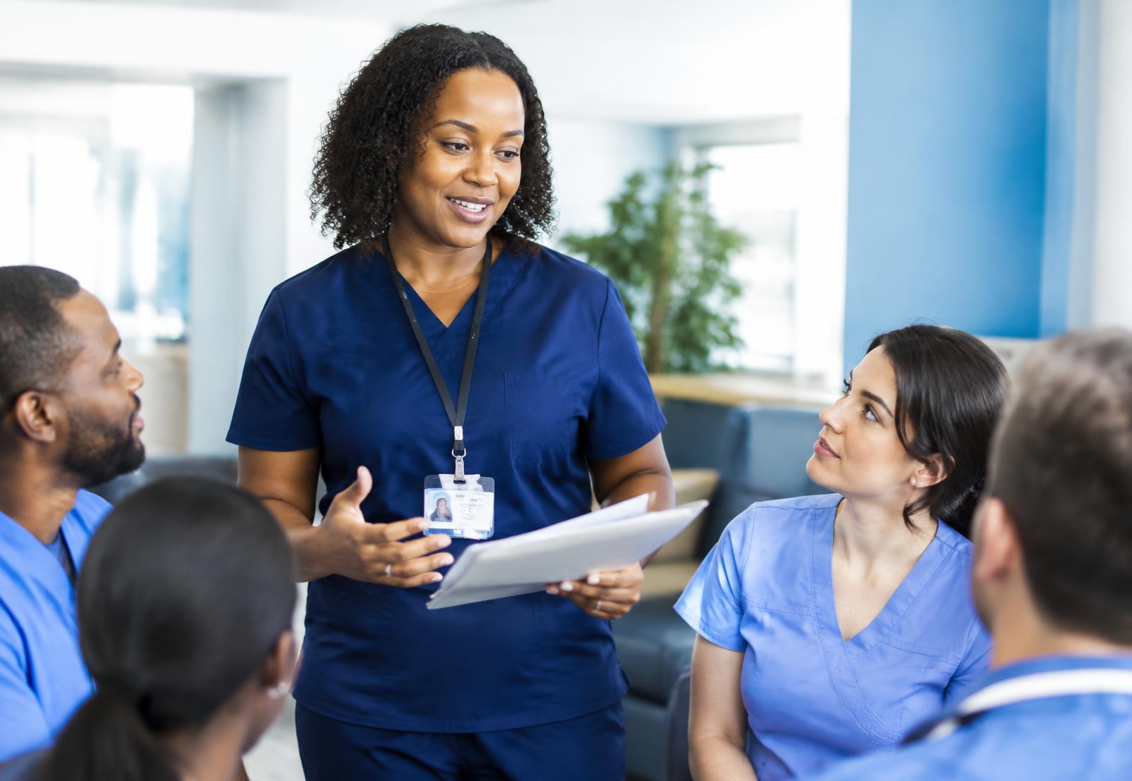 Nurse educator leading a discussion with nursing staff